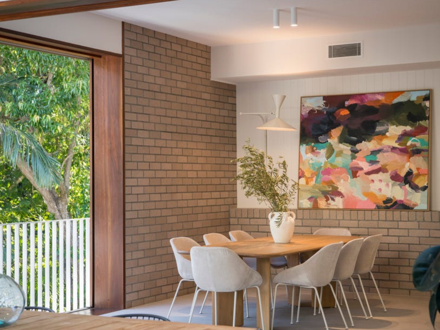 Dining space featuring curated artwork for hire in Bardon property styling project