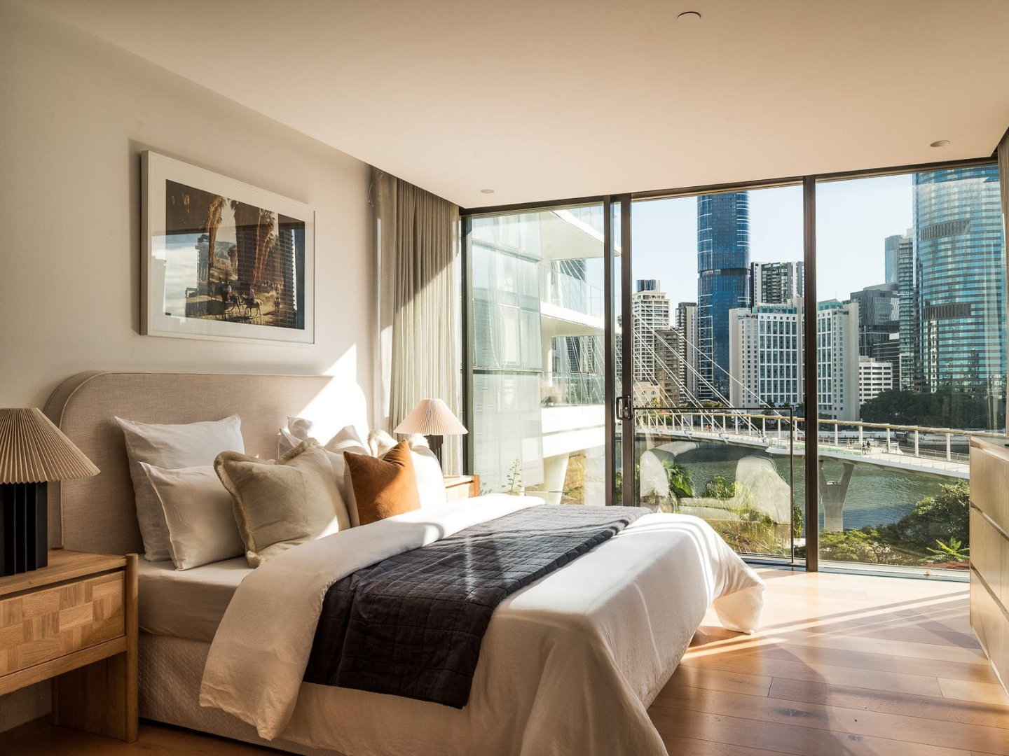 Bedroom styled with Slim Aarons  artwork for hire in Kangaroo Point apartment
