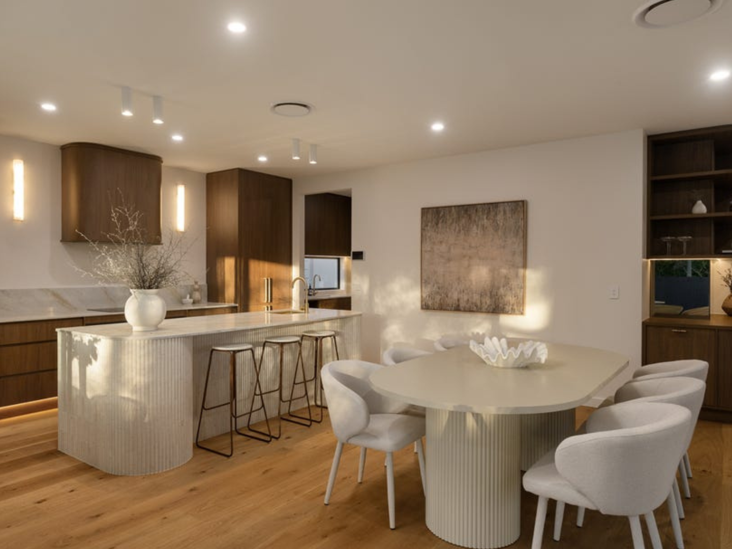 Modern kitchen and dining area with large abstract wall art hired for staging the home