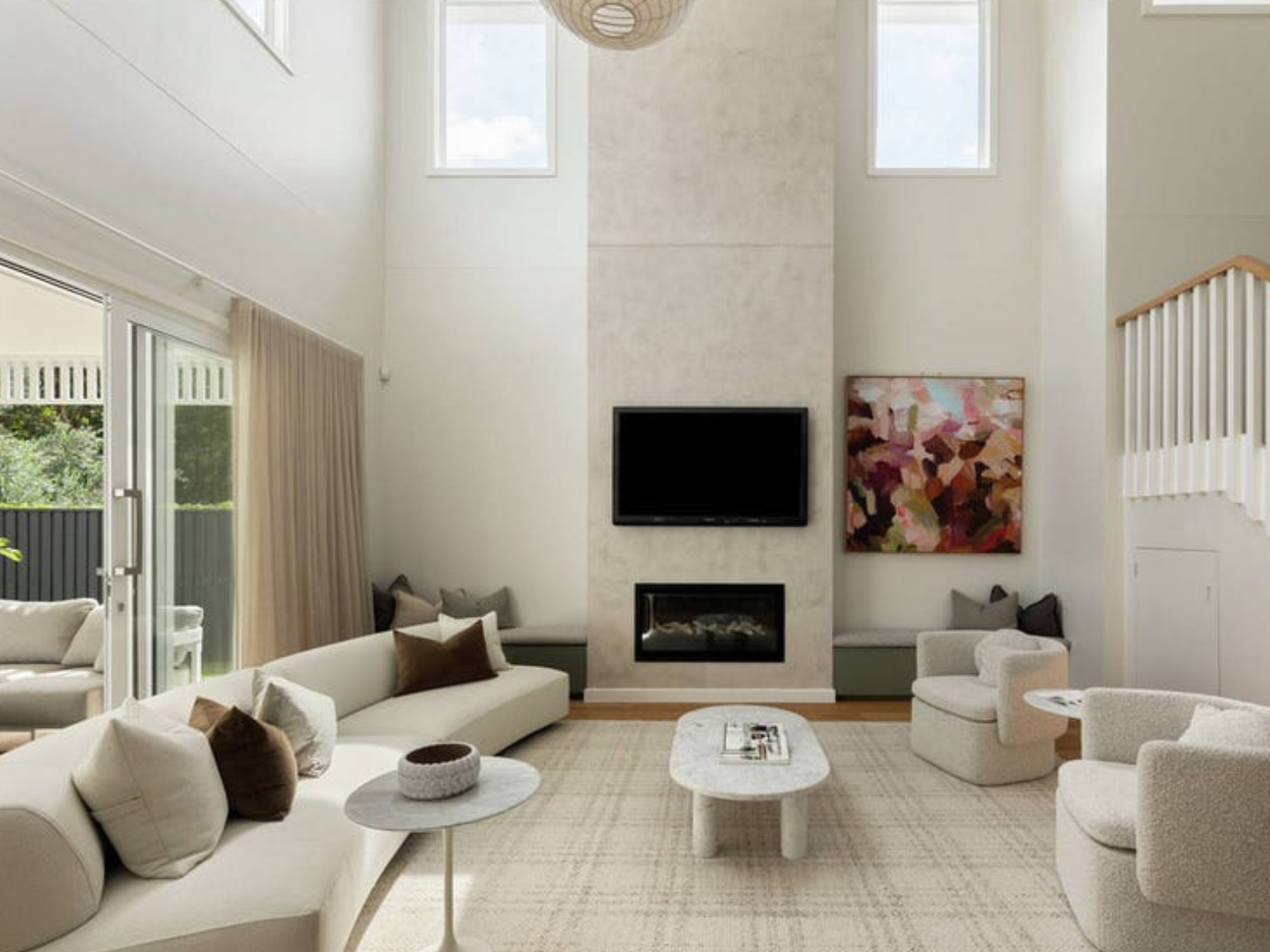 Modern living room with white furniture, fireplace, and artwork hired for home staging