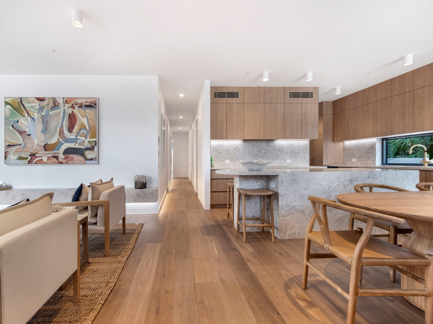 Modern open-plan kitchen and living room with large original abstract artwork hired for property styling in mermaid beach gold coast